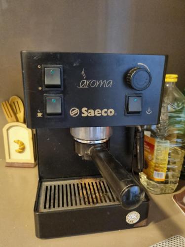 a black espresso machine sitting on a counter at CAL METGE in Benissanet