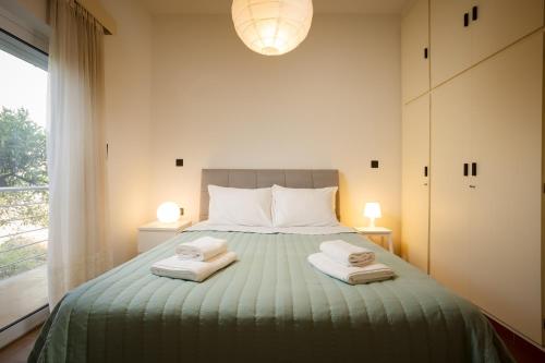 a bedroom with a bed with two towels on it at Mantarini House in Chania Town