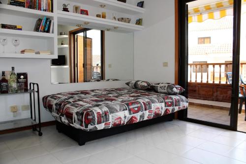 a bedroom with a bed and a large window at House El Cardon by Holiday World in Playa de las Americas