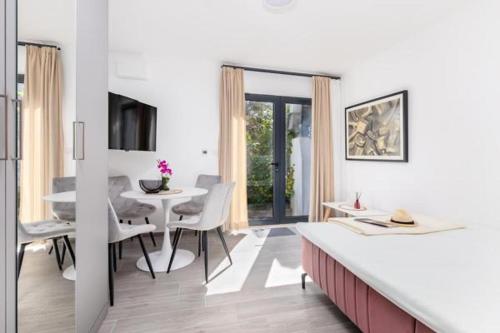 a kitchen and dining room with a table and chairs at Apartments Port View in Herceg-Novi
