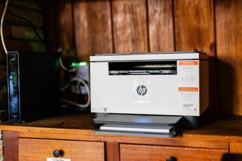 a printer sitting on top of a wooden cabinet at Highlands Escape with Views 5 Min to Downtown in Highlands