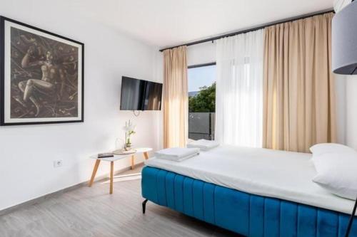 a bedroom with a large bed and a window at Apartments Port View in Herceg-Novi