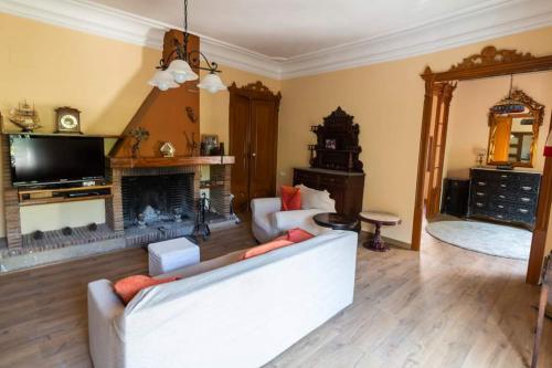 a living room with a couch and a fireplace at CAL METGE in Benissanet