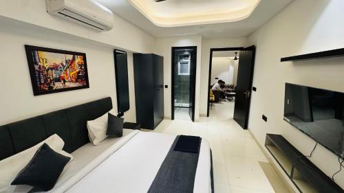 a living room with a couch and a television at Reebah Inn & Suites in Gurgaon