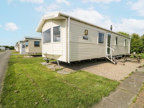 a white trailer parked on the side of a road at Manor House Gold 2 Bedroom 20C in Maryport