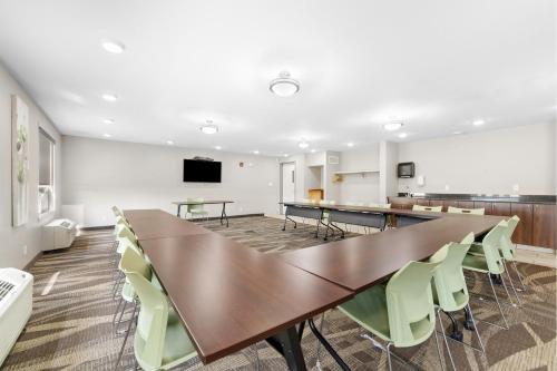 a conference room with a long table and chairs at Home Inn and Suites Lloydminster in Lloydminster