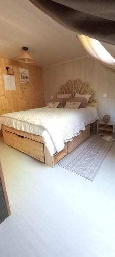 a bedroom with a large bed in a room at Country Cottage & Spa in Labalme