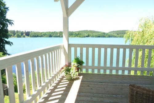 a porch with a view of the water at Seehotel Lindenhof in Lychen