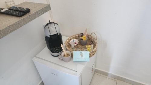 a kitchen with a counter with a blender on top of a refrigerator at Dionysus House Lasithi Plateau in Magoulás