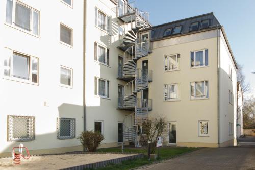 a large white building with a fire escape at Hotel Pankow in Berlin