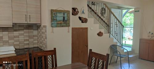 a kitchen with a staircase and a table and chairs at Diogenis villa in Vourvourou