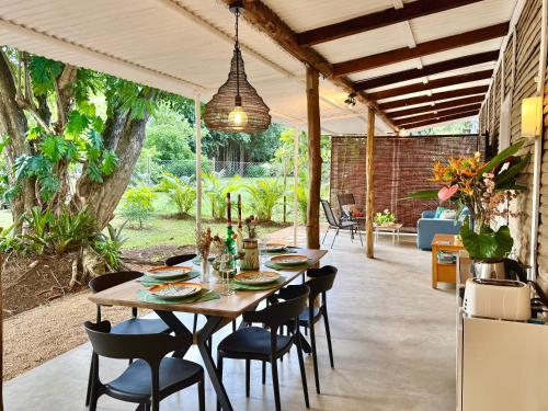 a table and chairs under a pavilion in a garden at Lakaz Kalo - house with garden and service in Grand Gaube