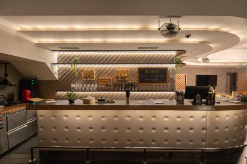 a kitchen with a bar in a restaurant at Wellness Hostel Central in Prague