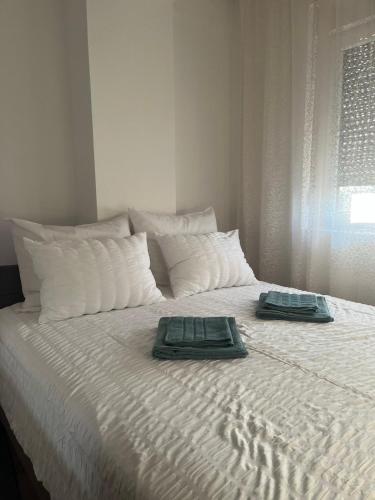 a bed with two towels on top of it at IL Paradiso potok akva park in Jagodina