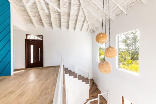 a hallway with white walls and a wooden ceiling at Caicos Cove Villa 4BR, Pool, 5 mins to Grace Bay in Leeward