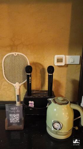 a tea kettle and a toaster on a counter at Xieng Retreat in Hanoi