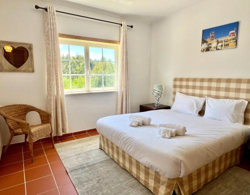a bedroom with a bed with two towels on it at Apt T3 - Golf&Surf Praia Del Rei in Amoreira