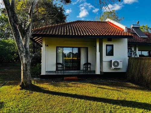 a small house with a table and chairs in a yard at Foresta Resort Sigiriya in Sigiriya