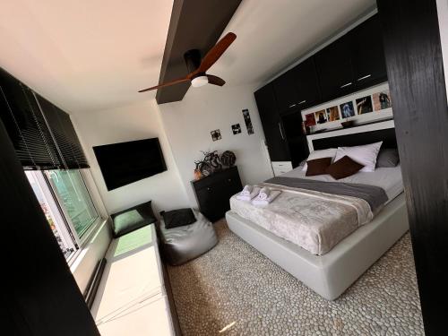 a bedroom with a bed and a ceiling fan at Rijeka Fiorino Apartment in Rijeka
