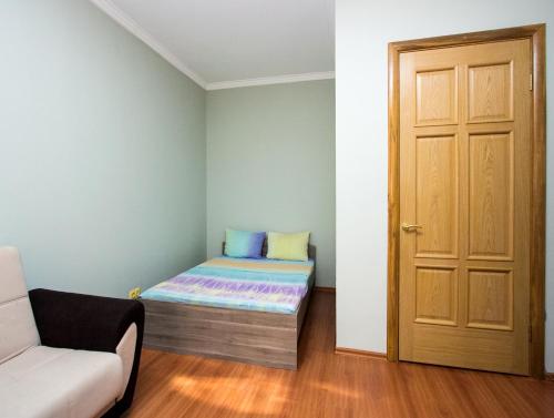 a small room with a bed and a door at ApartLux Park Pobedy 2 in Moscow