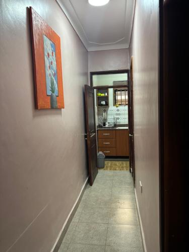 a hallway leading to a bathroom with a sink at Bukoto Kampala Kickoff Ntinda Luxury apartment in Kampala