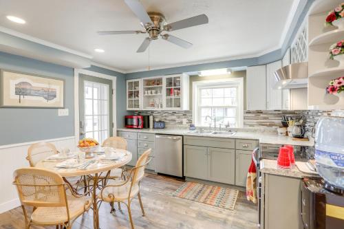 a kitchen with a table and chairs and a ceiling fan at 1 Block to Beach Home with Hot Tub in Port Clinton! in Port Clinton