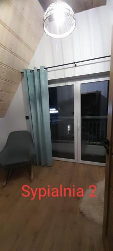 a room with a window and a chair and a light at Domek u Socków in Zakopane