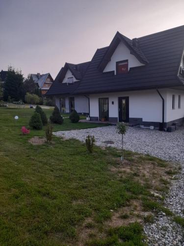 a white house with a black roof at Domek u Socków in Zakopane