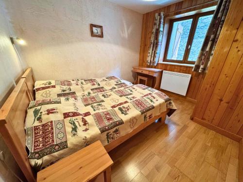 une chambre avec un lit avec une couette dessus dans l'établissement Appartement familial à St Martin de Belleville - 3 chambres, terrasse, parking, près des commerces et pistes - FR-1-452-118, à Saint-Martin-de-Belleville