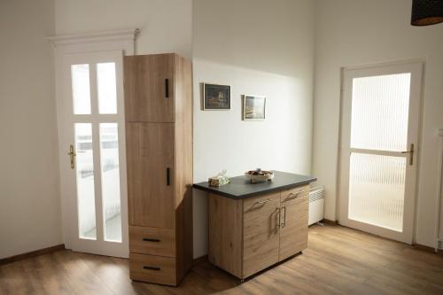 a room with a wooden cabinet and a door at Elek Garden Apartman in Budapest