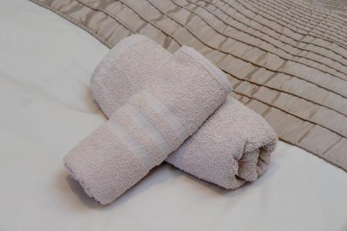 a teddy bear with a bandaged foot on a bed at Eur Trepini Luxury Loft in Rome