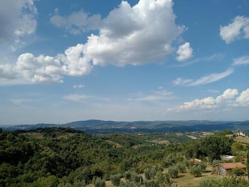 a view of a valley with trees and clouds at IL BORGHETTO Room&Breakfast in Rocca San Casciano