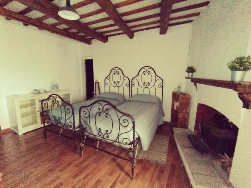 a bedroom with a bed and a fireplace at IL BORGHETTO Room&Breakfast in Rocca San Casciano