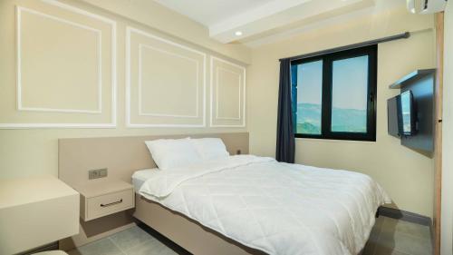 Ένα ή περισσότερα κρεβάτια σε δωμάτιο στο Damira Apart