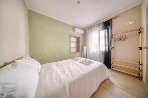 a bedroom with a white bed and a window at Pepita home in Chios