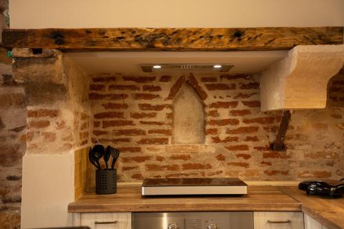 a kitchen with a counter with a stone wall at Pepita home in Chios
