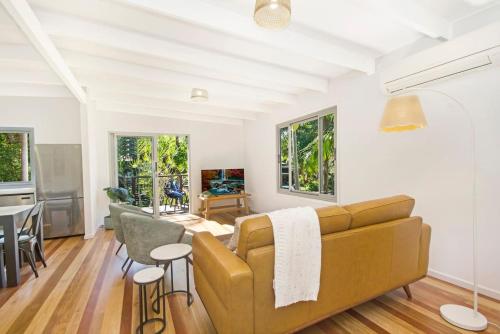 a living room with a couch and a table at South Golden Beach House - Tranquil Family Getaway in South Golden Beach