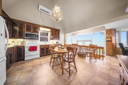 a kitchen with a table and chairs and a dining room at Le Repaire du Fleuve in Sainte-Croix