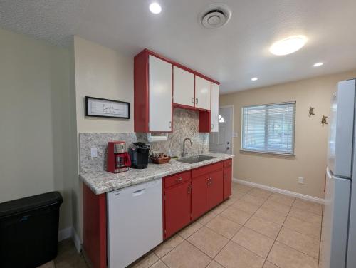 a kitchen with red cabinets and a white refrigerator at Ruth Hill Hideaway in Squaw Valley