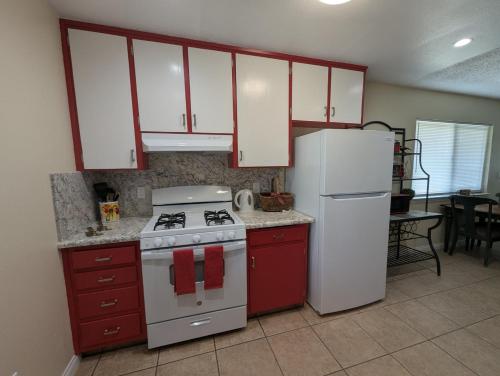 a kitchen with red cabinets and a stove and refrigerator at Ruth Hill Hideaway in Squaw Valley