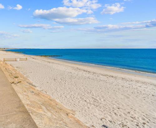 a sandy beach with the ocean in the background at Gorgeous Home 1 mile to Beach and near Cape Cod Bikepath in Dennis