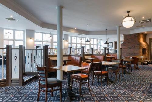 a dining room filled with tables and chairs at Pilgrims Progress Wetherspoon in Bedford