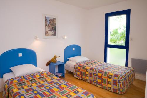 Krevet ili kreveti u jedinici u okviru objekta Madame Vacances Villas Club Royal Aquitaine