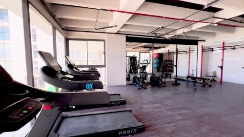 a gym with treadmills and machines in a room at Apartamento nuevo con vista al mar, Santa Marta in Santa Marta
