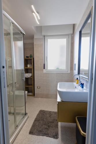 a bathroom with a sink and a shower at Penthouse genneruxi in Cagliari
