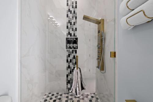 a bathroom with a shower with a glass door at Oasis Paradise at Cape Coral in Cape Coral