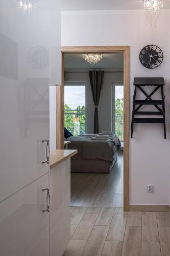 a bedroom with a bed and a clock on the wall at Rezydencja Wrocław Legnicka in Wrocław