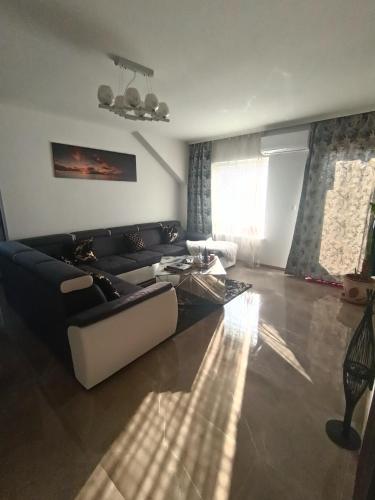 a living room with a couch and a table at Apartmani Jozić in Garešnica