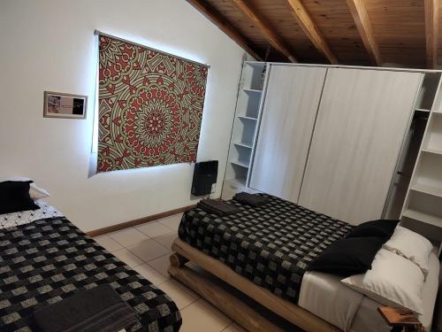 a bedroom with a bed and a painting on the wall at La Posada de Buda in Malargüe