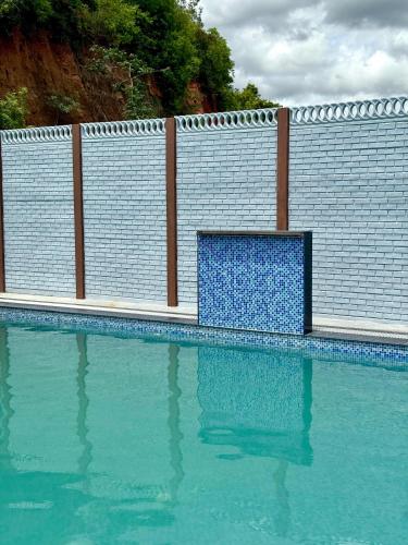 a swimming pool with a blue bench in the water at KS Valley in Rāmanagaram